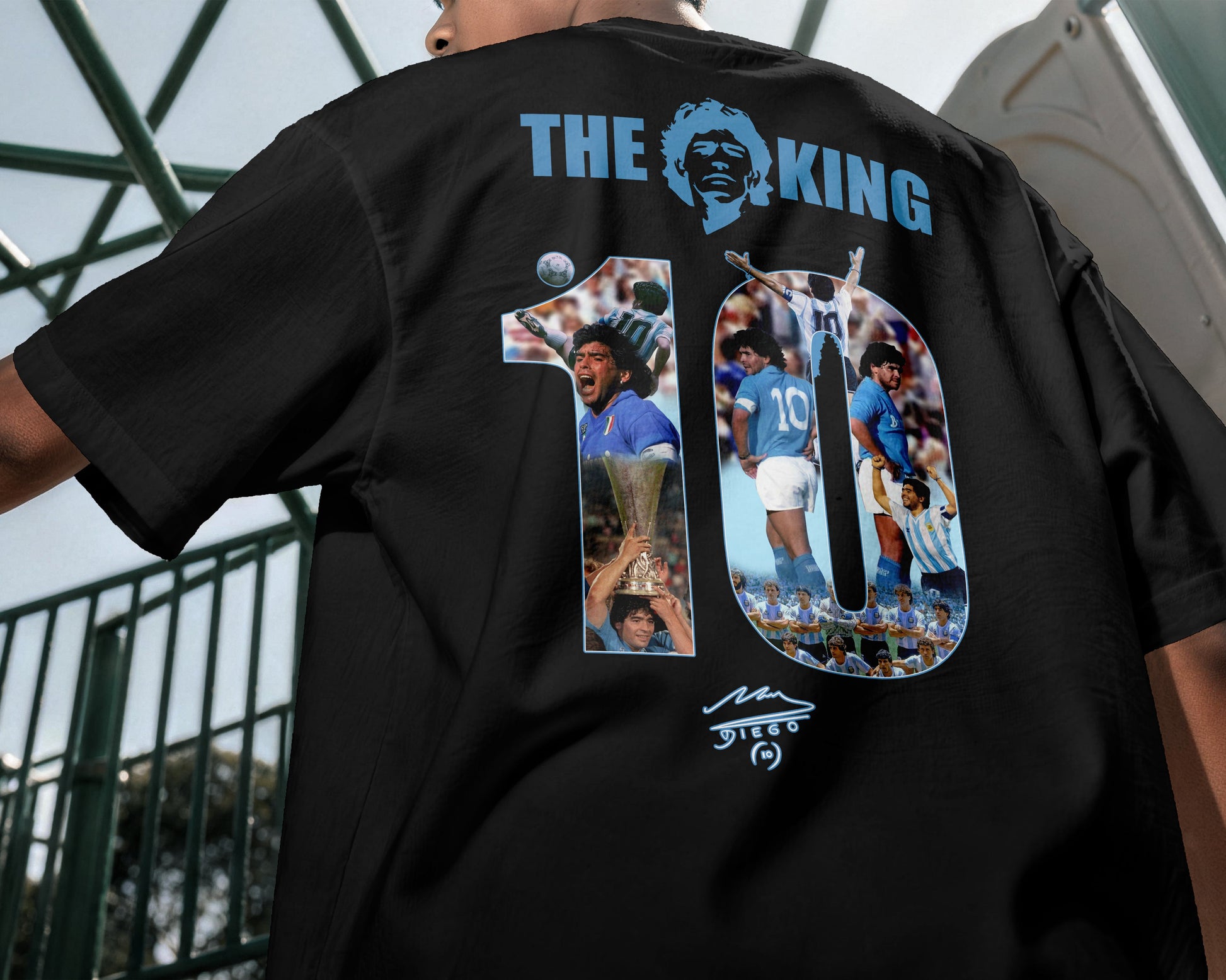 Black t-shirt with graphic design and text on the back, worn by a person.