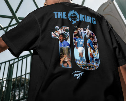 Black t-shirt with graphic design and text on the back, worn by a person.