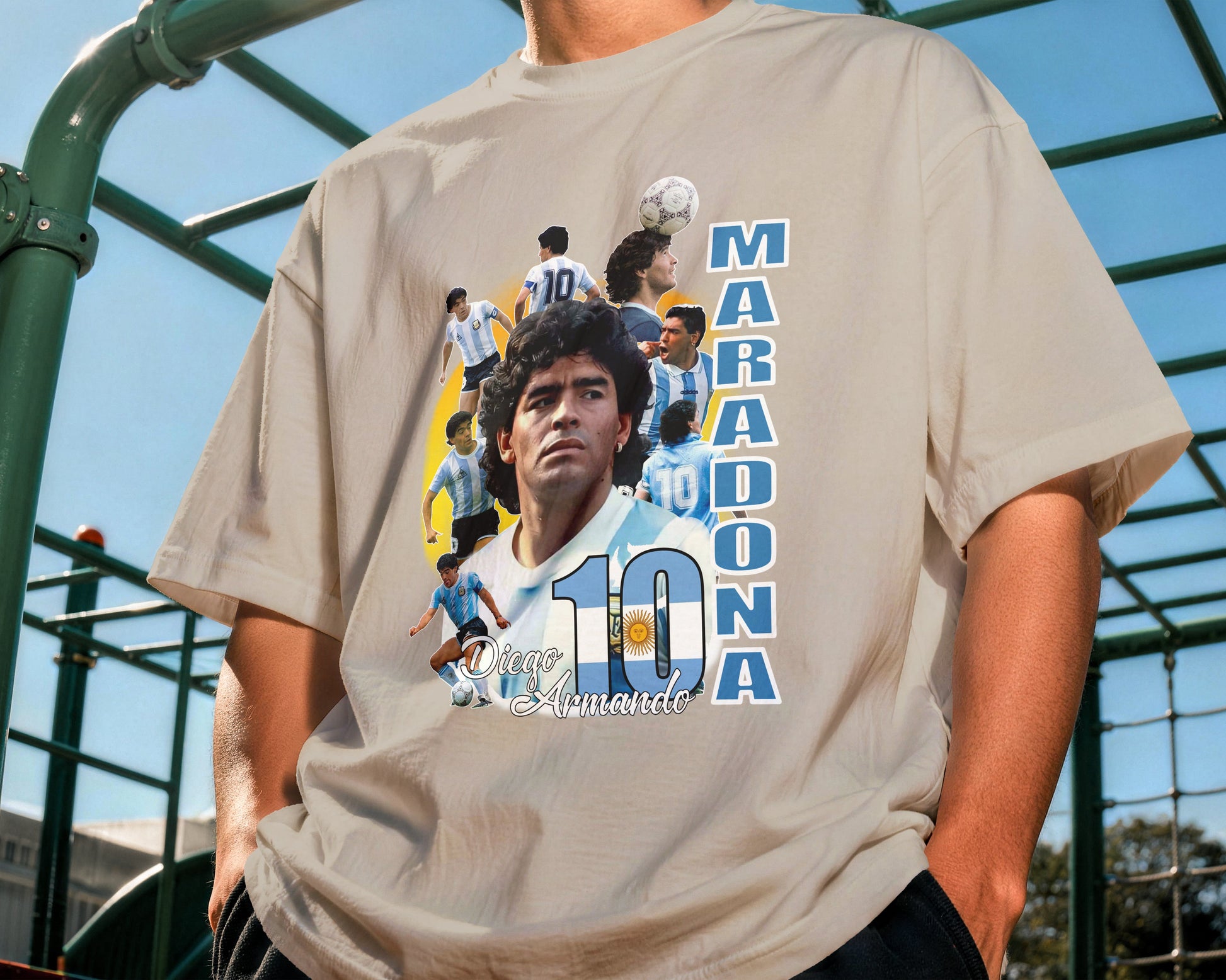 Person wearing a t-shirt with a graphic of a famous soccer player and the number 10, outdoors.