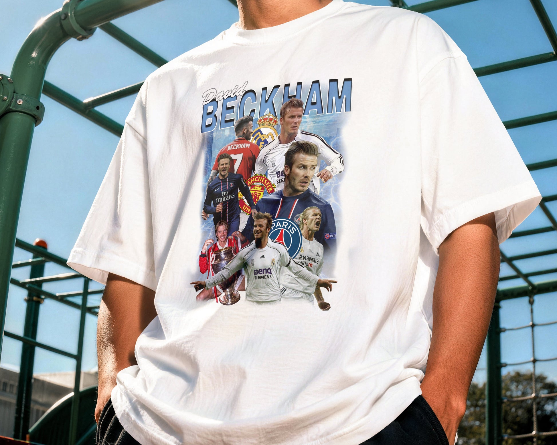 Person wearing a white t-shirt with multiple images of a famous soccer player on a playground.