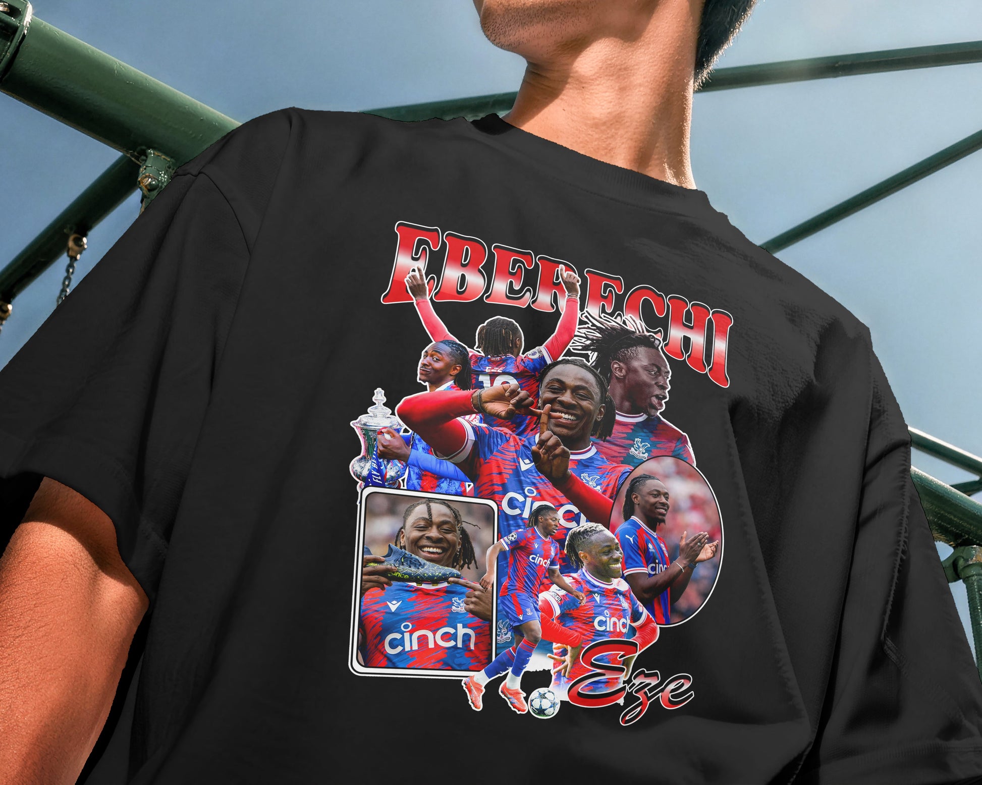 Person wearing a black t-shirt with colorful graphics and text, standing outdoors.