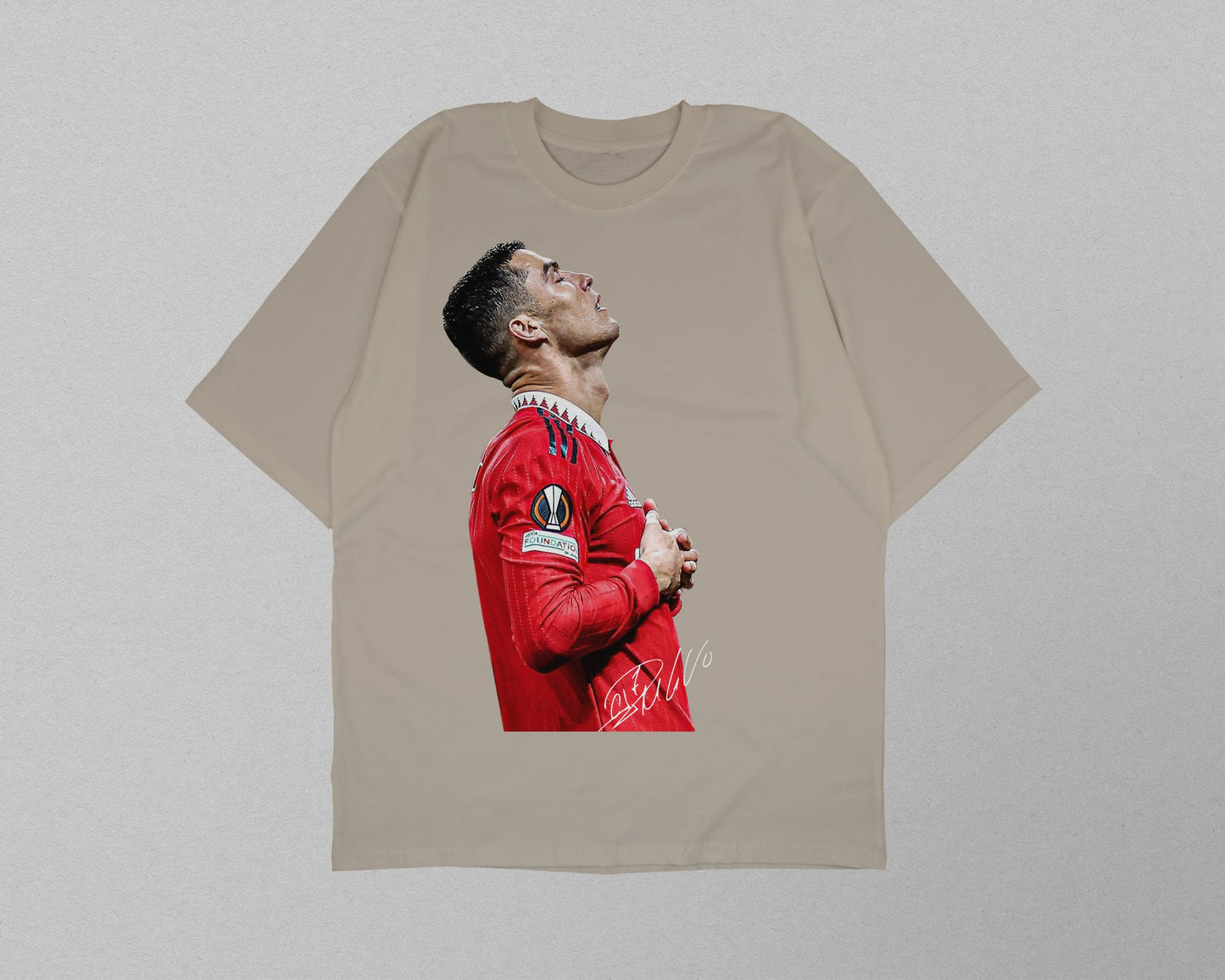 Beige t-shirt with a printed design of a person in a red sports jersey on a light gray background