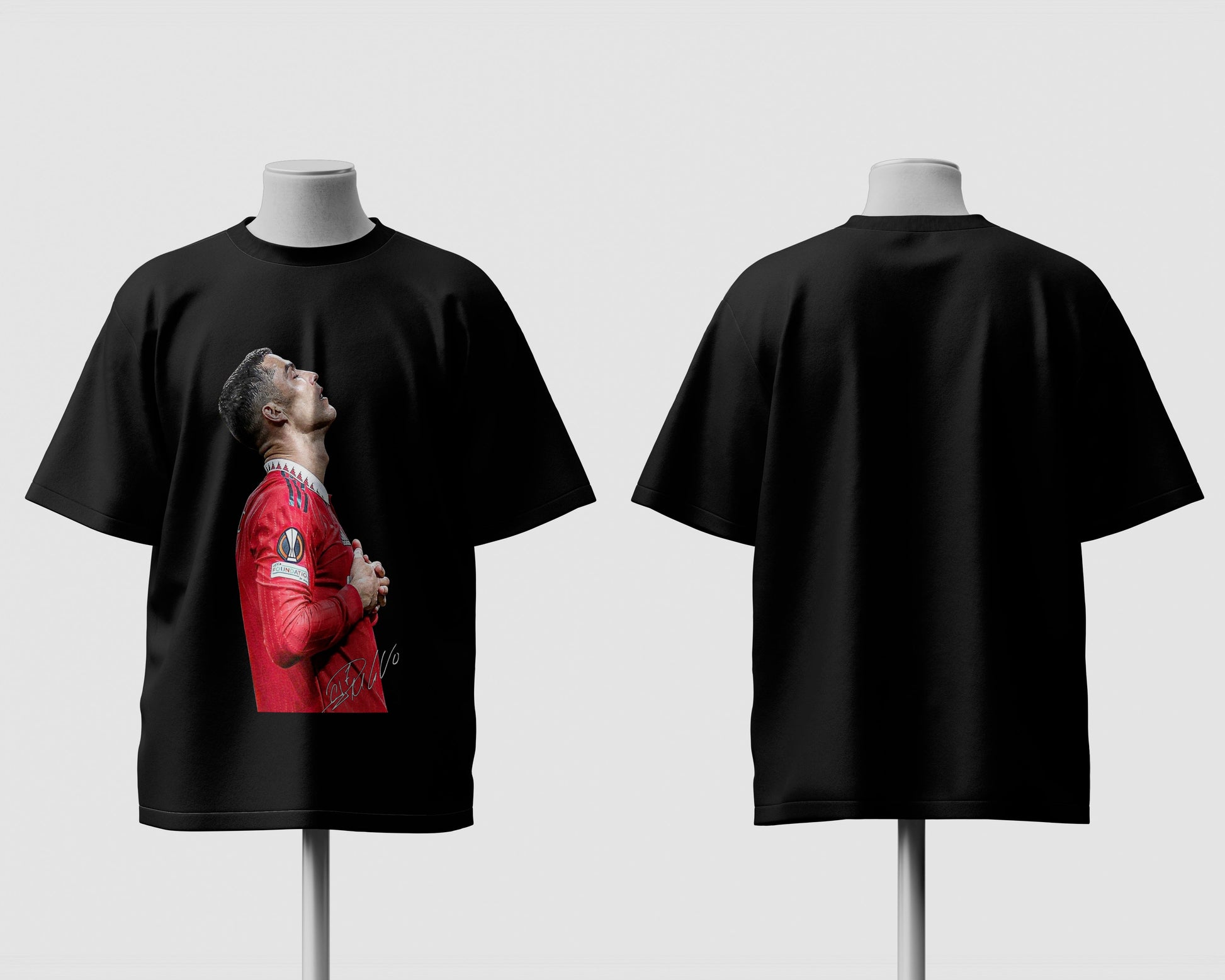 Black t-shirt with a graphic of a person in a red outfit on a mannequin against a white background