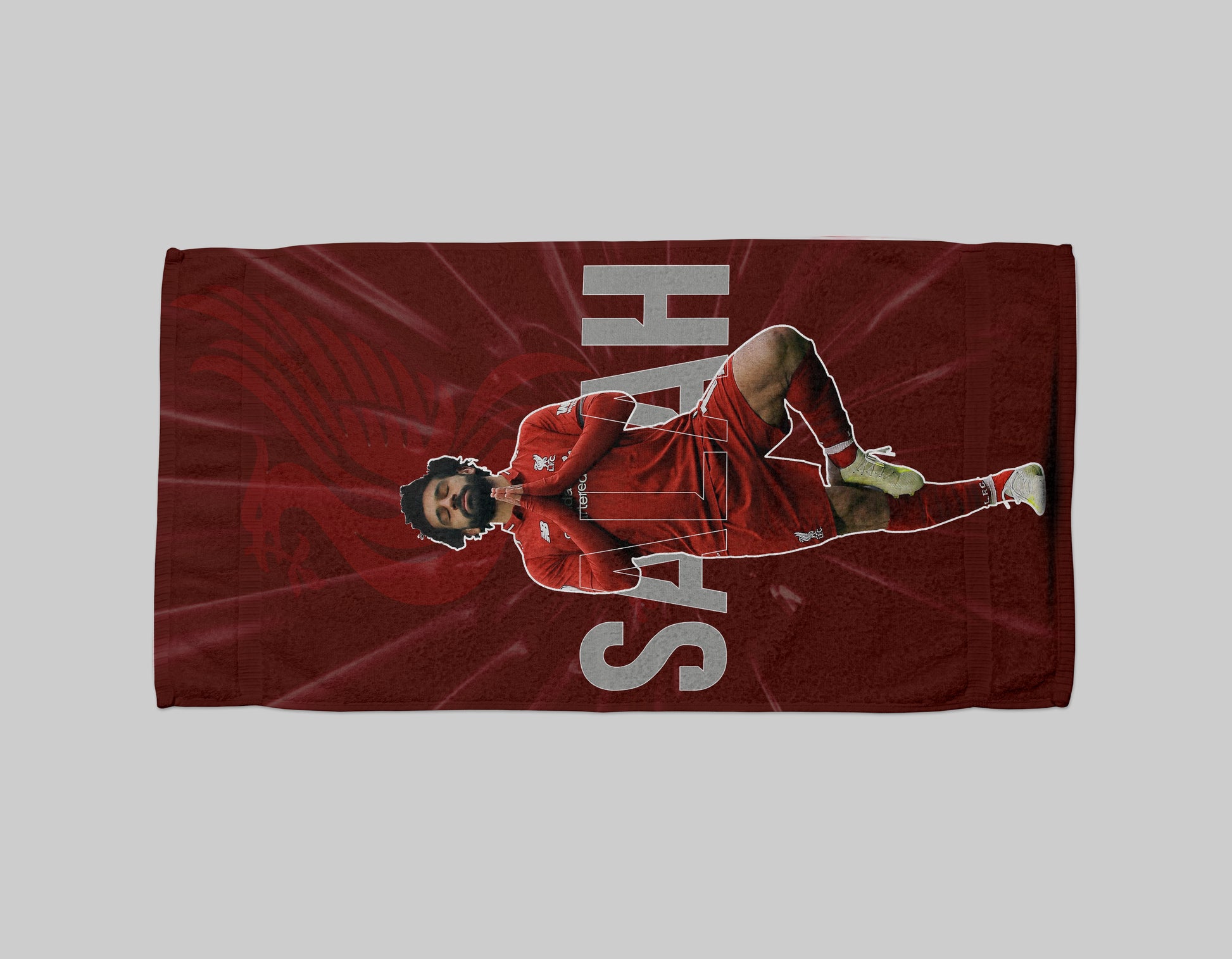 Red towel with a graphic of a person in a red outfit and 'SAH' text on a gray background